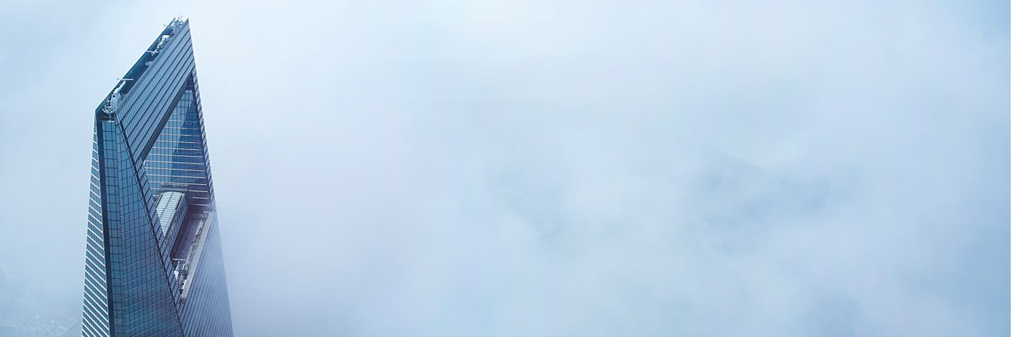 Skyscraper cutting through clouds
